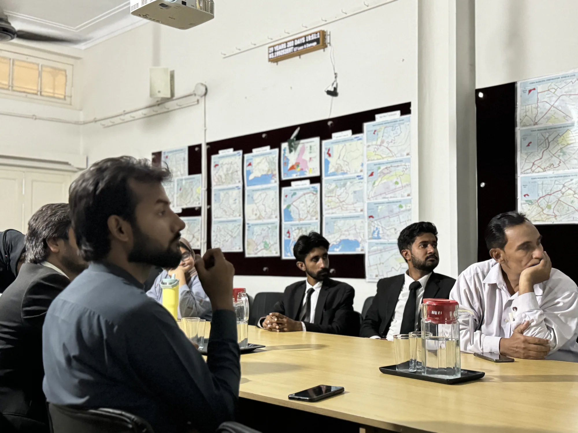Green Chamber workshop participants reviewing ideas displayed on a wall